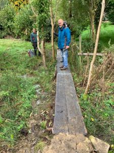 Volunteer standing on the newly repaired bridge